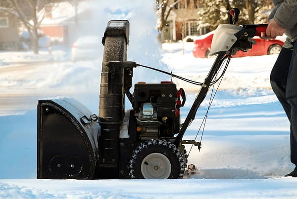 Snowblower in use on a snowy driveway
